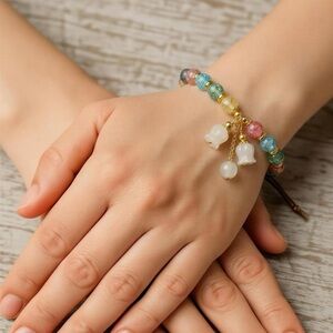 Multicolor Beaded Bracelet with Gold Accents and White Charms